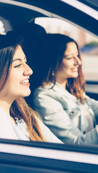 happy-girls-friends-in-a-car-on-trip.jpg